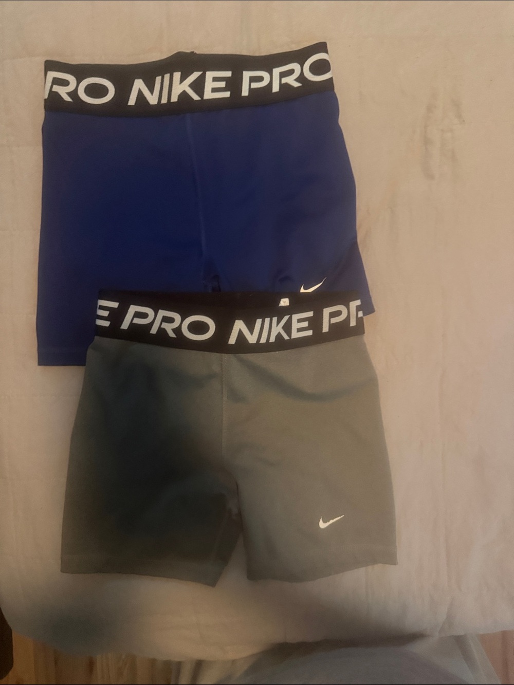 4 pairs of Nike kids compression shorts  pink, blue and grey